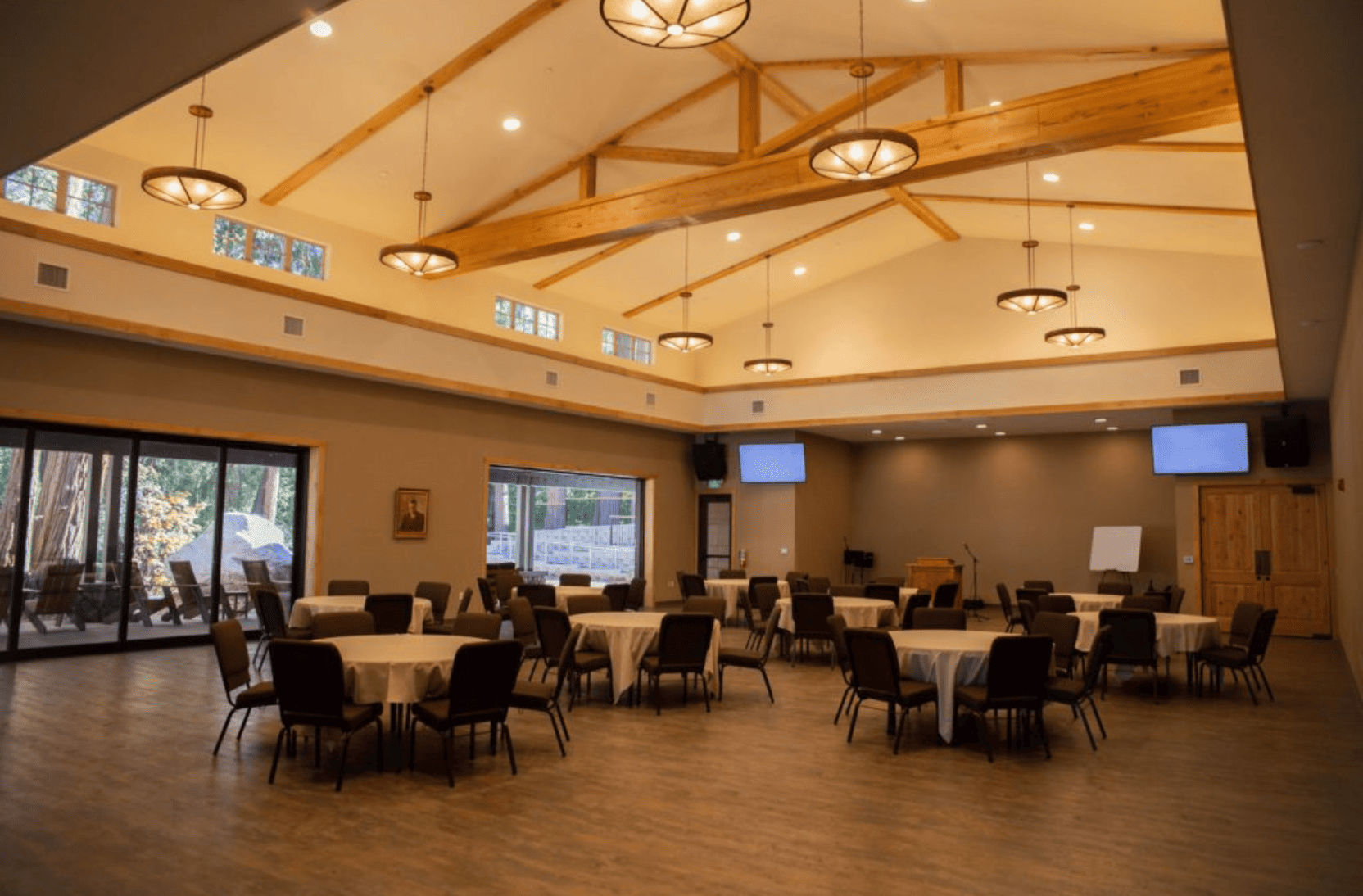 Indoor meeting space at Forest Home with round tables and chairs set up