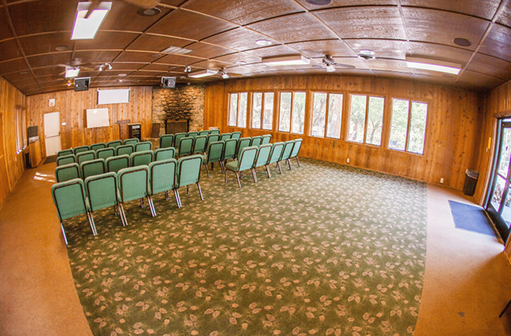 Inside pines lodge with chairs set up for a meeting