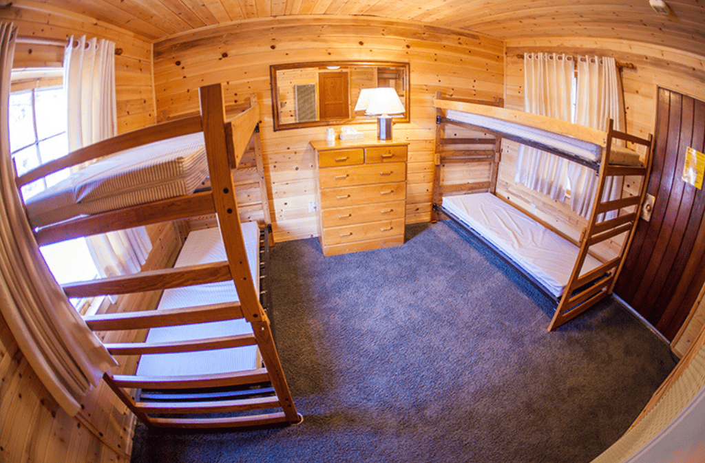 Inside room with two sets of bunk beds and a dresser